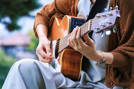 Free Photos | Girl playing acoustic guitar on a park bench