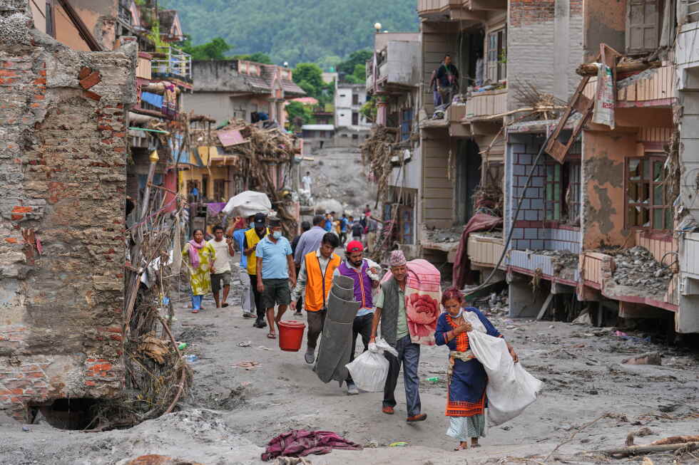 Rescuers search for thousands after floods at Nepal-China border | AP News